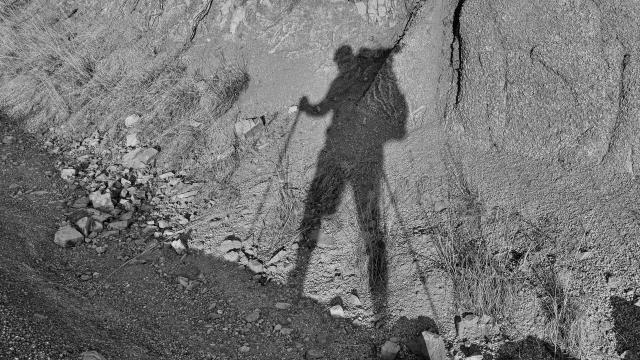 Gravity's shadow on the side of a rock slope
