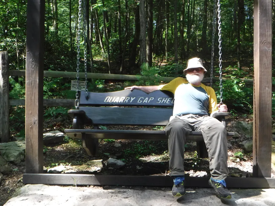 Stick relaxing in Quarry Gap Shelter bench swing