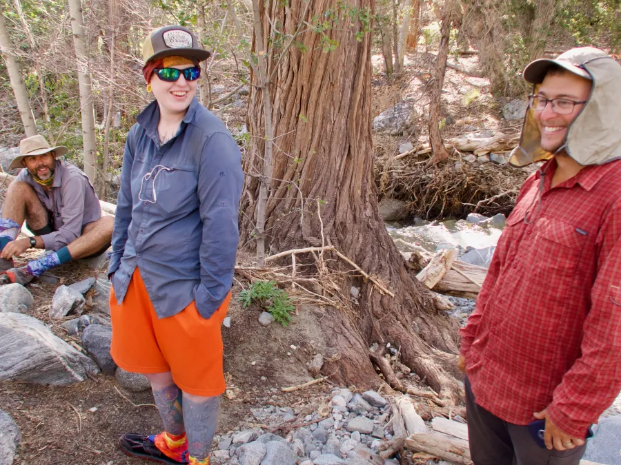 The tramily takes a break at a stream