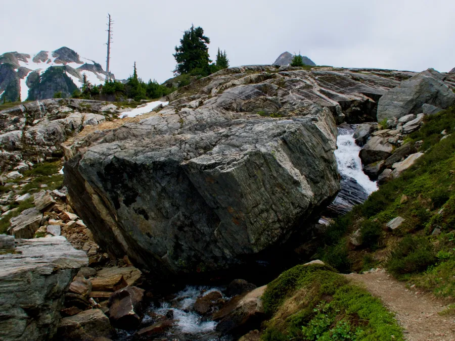 A large boulder covers the trail