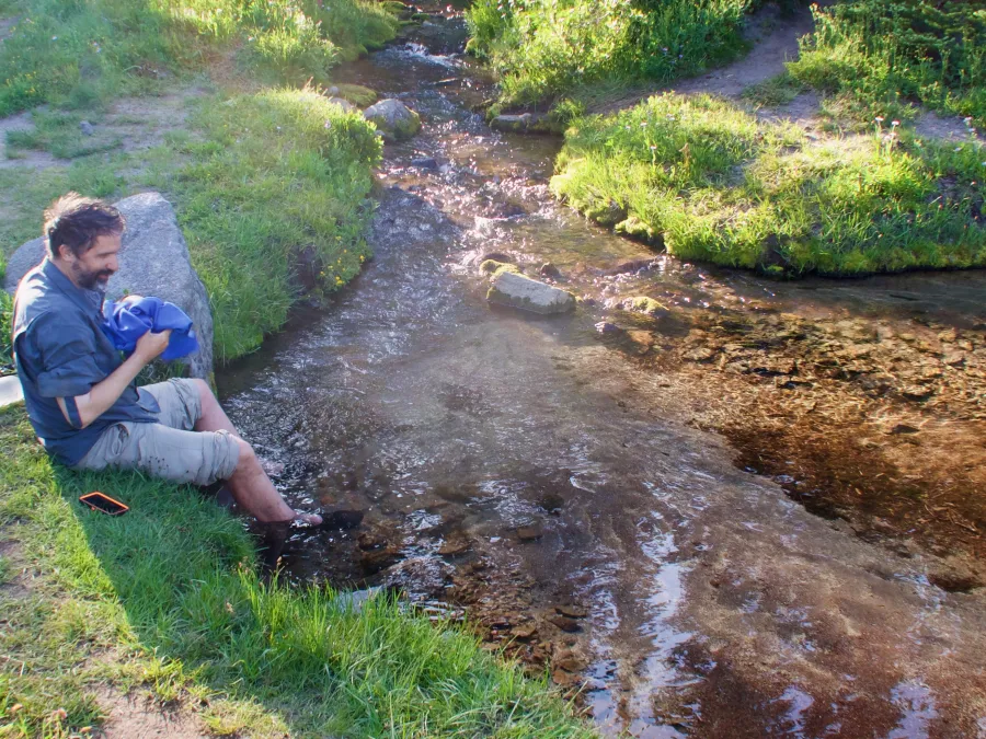 Dave soaks his feet in the pool by the waterfall