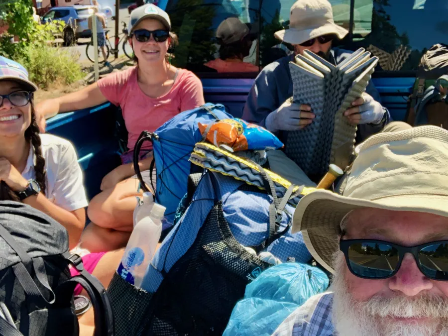 Riding the back of a pickup truck back to the trail