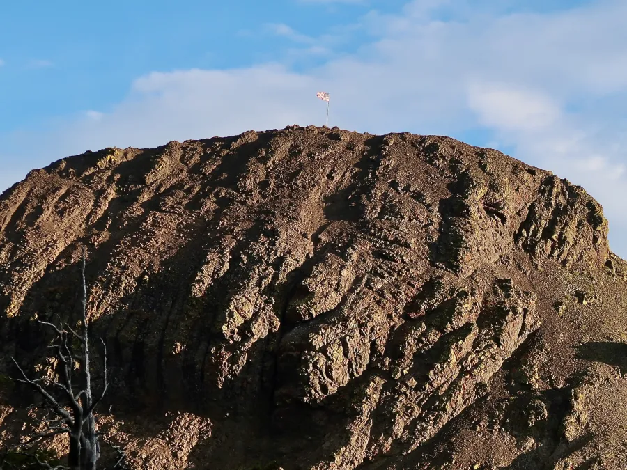 An American flag stands on Ebbetts Peak