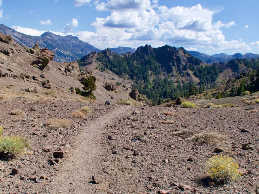 The trail crosses a gravel ridge