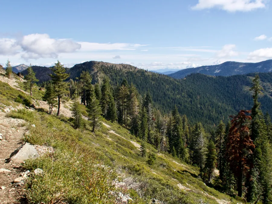 The trail takes a high path over a ridge