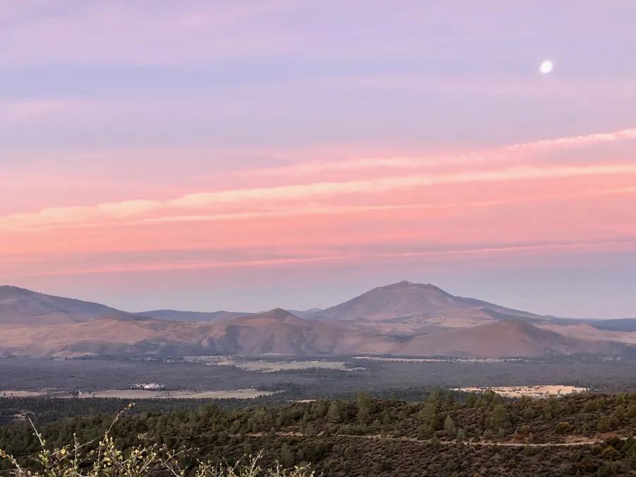 The moon hangs over Burney Mountain at sunrise