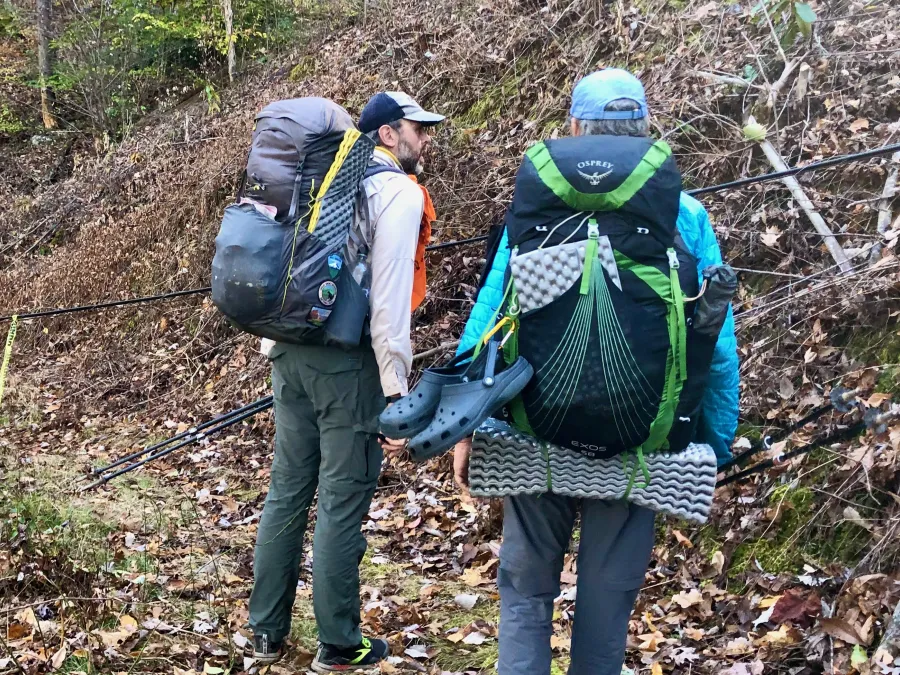 Just Awesome and Tengo Hambre inspect a cable across the trail