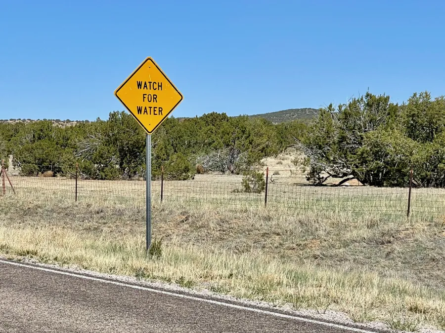 A warning sign says watch for water