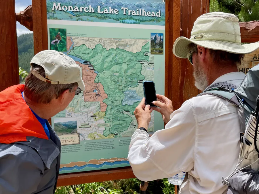 Looking at a trail map at Monarch Lake
