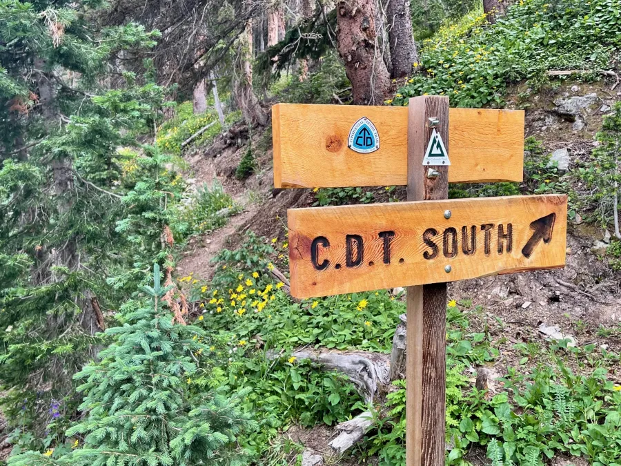 A sign points to a new trail section