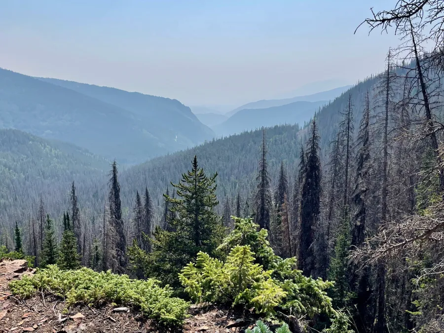 Smoke obscures a view of distant mountains