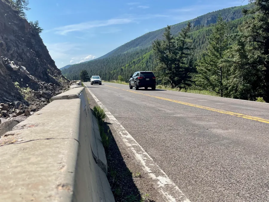 A concrete barrier blocks the highway shoulder