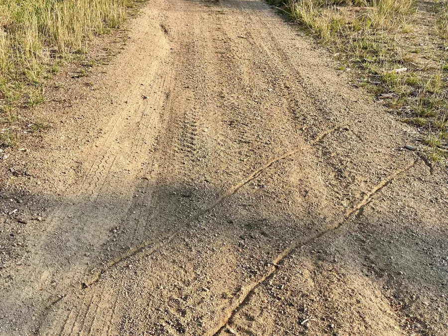 Arrows scratched in a gravel road