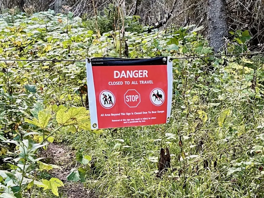 A sign says a trail is closed