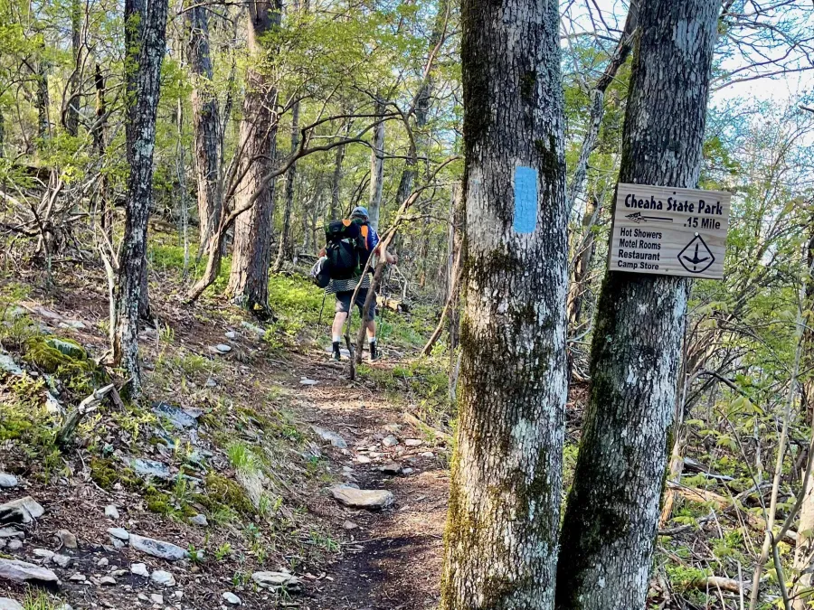Walking past a sign for Cheaha state Park