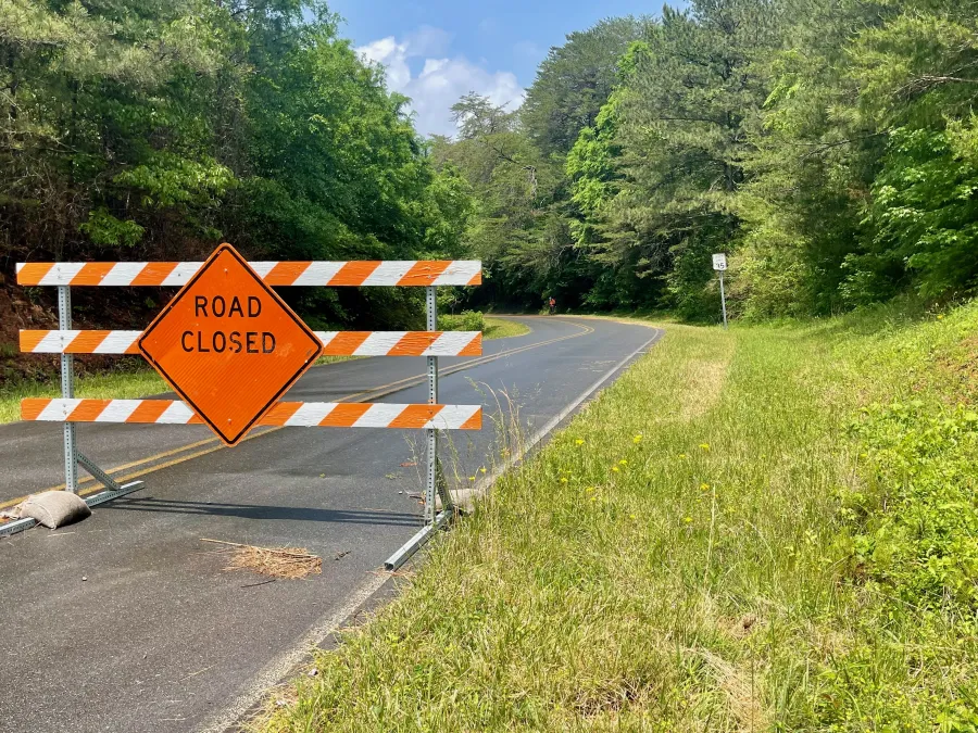 A large barrier blocks Dennis Mill Road