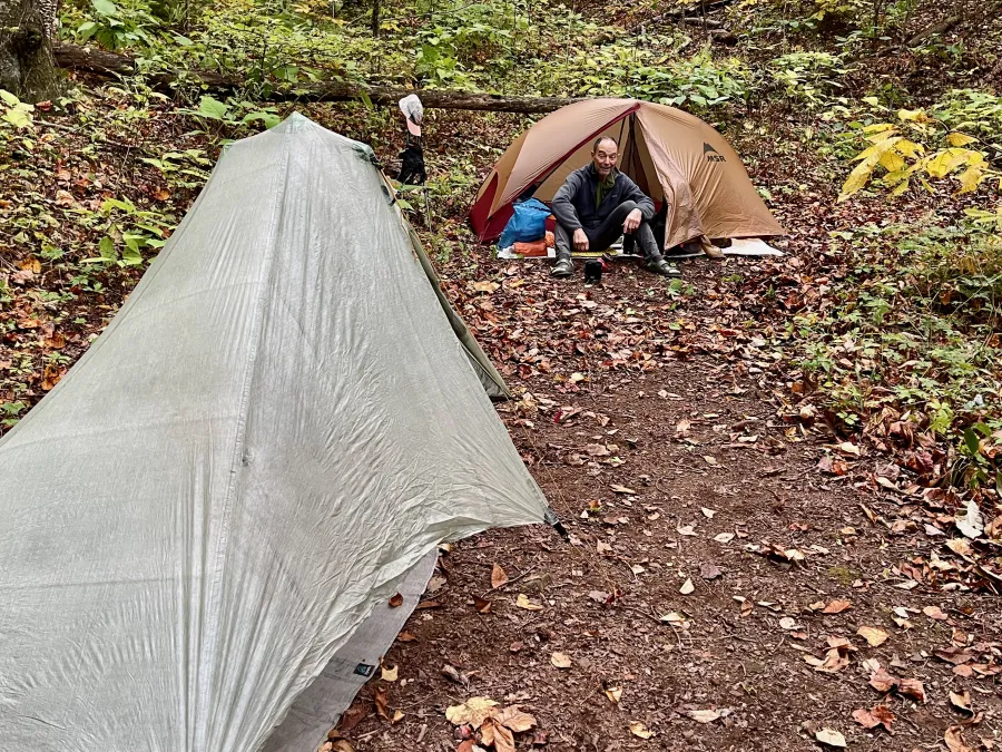 Polecat sits by his tent