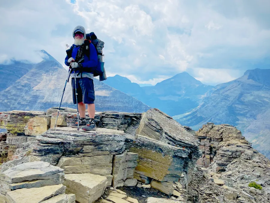Gravity standing on a rock overlooking a deep valley