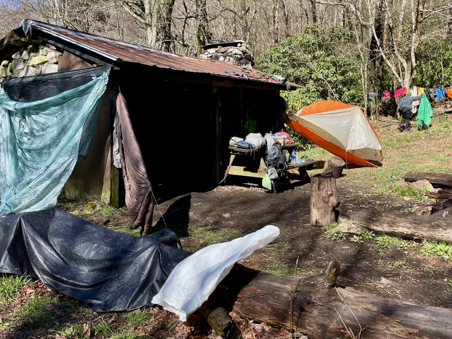 Wet tents, clothing, and other gear set out to dry
