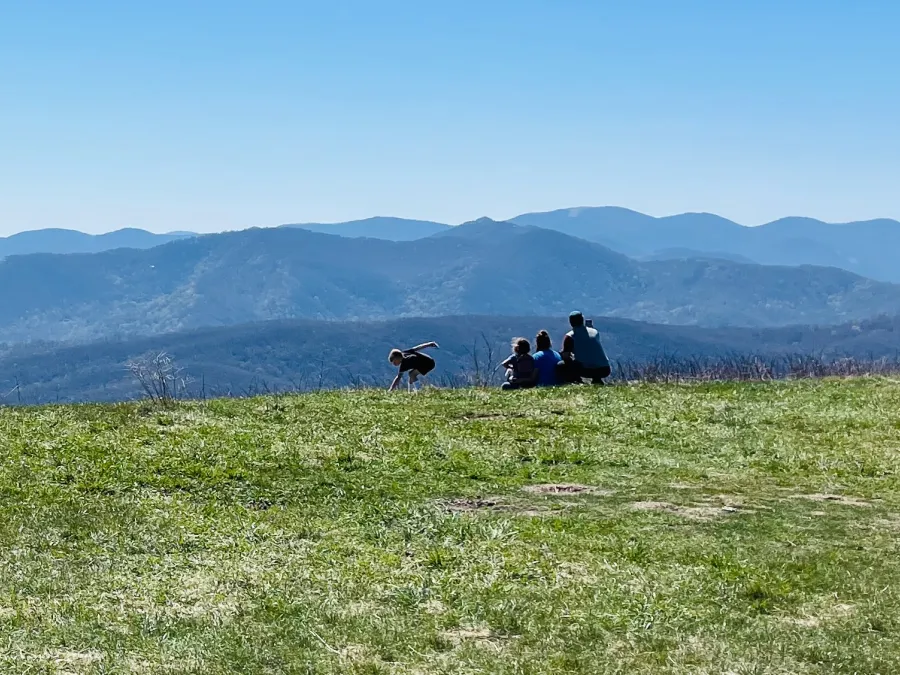 A family enjoys the view from Max Patch