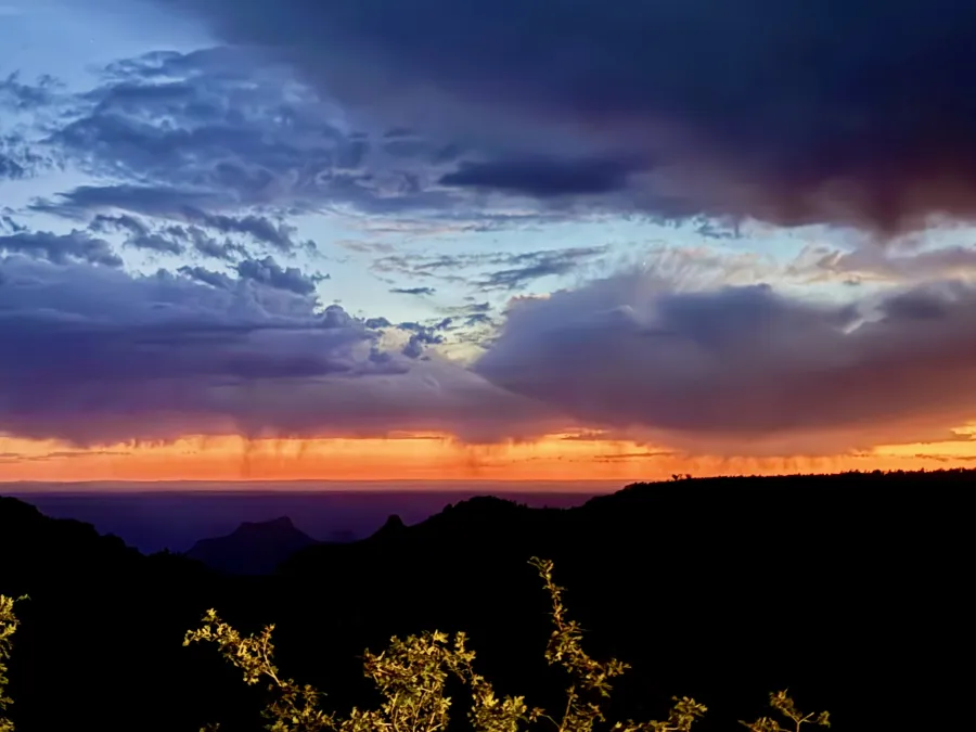 A distant storm at sunset over the Grand Canyon