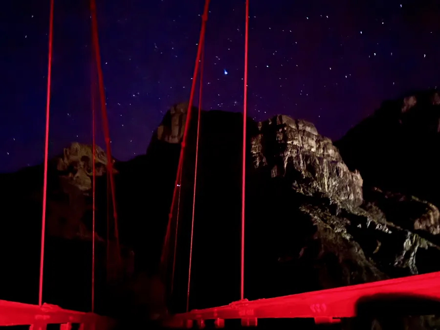 Cables on the Black Bridge glow red because of the light of headlamps