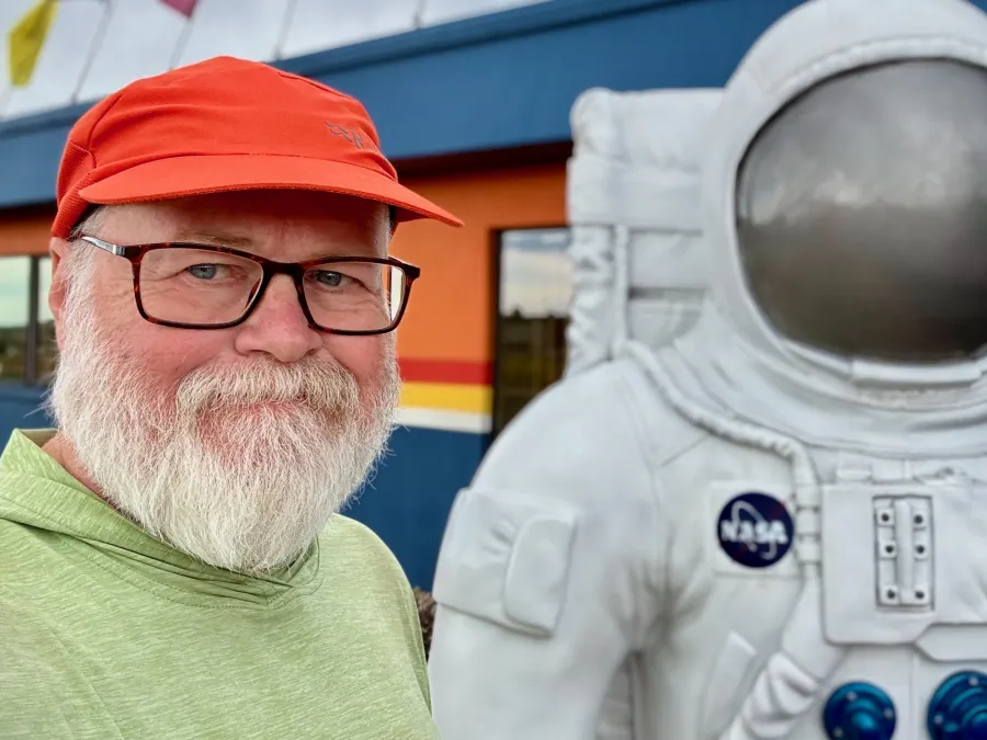 Gravity standing next to an astronaut statue