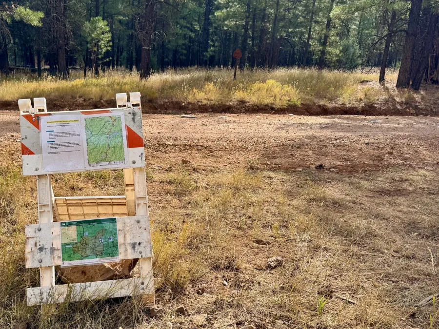 Information posted on a barricade announcing a trail closure