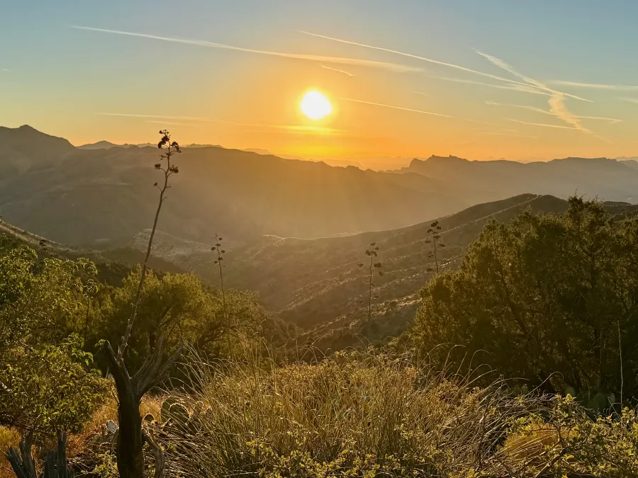 The sun sets behind the Superstition Mountains