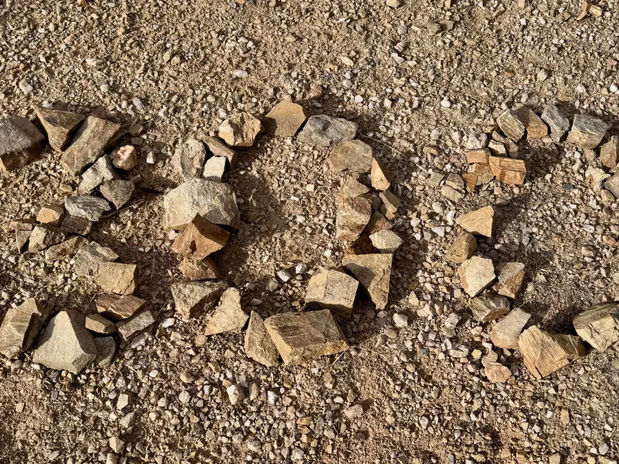 The number 300, written with small rocks
