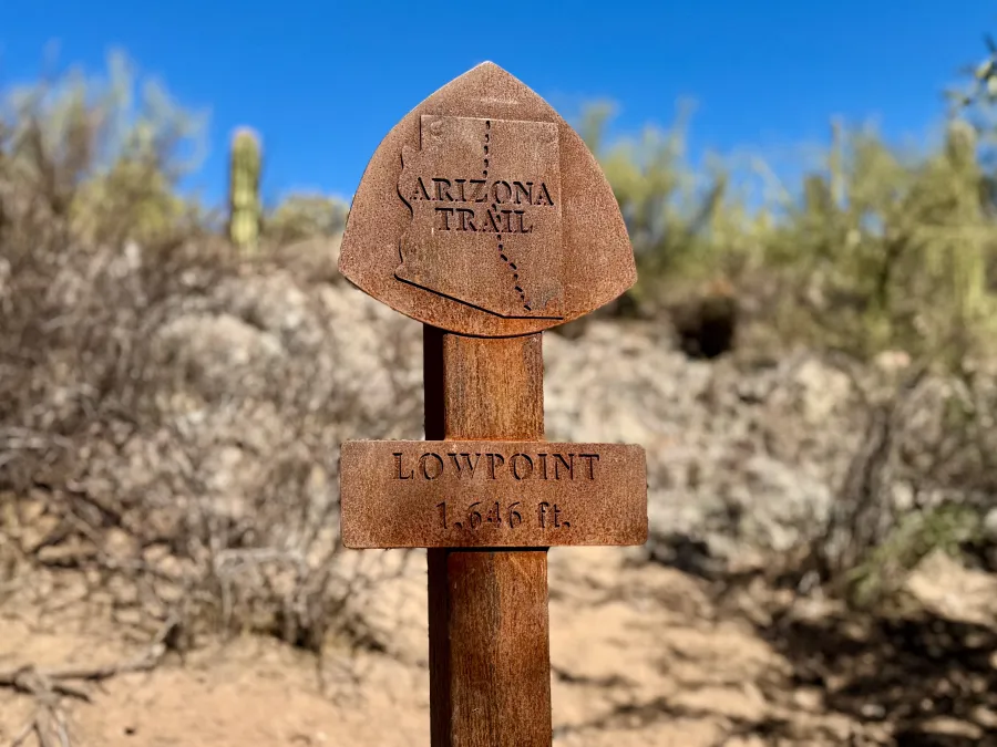 A metal sign marks the AZT's lowest point