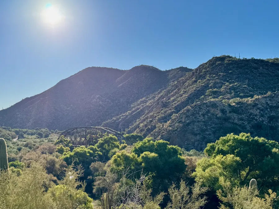 A bright sun hangs over the Gila River Canyon