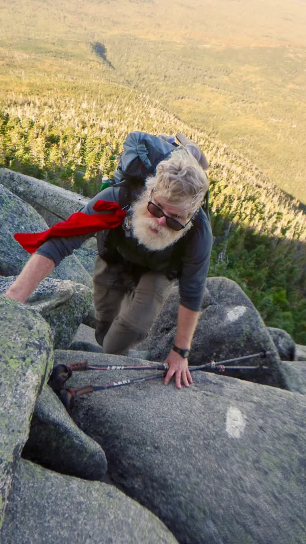 Stick climbs rocks on Mt. Katahdin