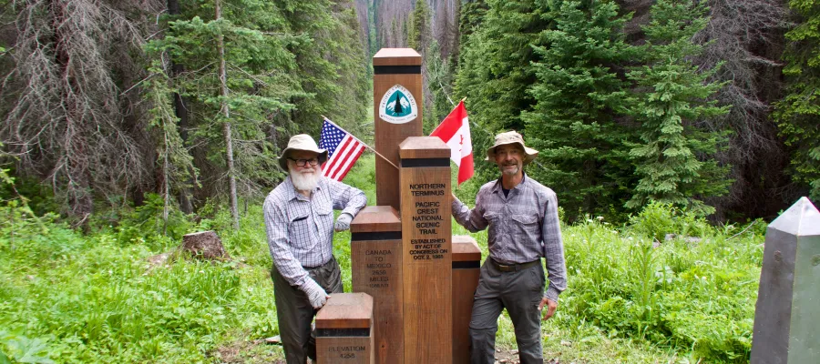 Gravity and Polecat standing at the northern terminus monument