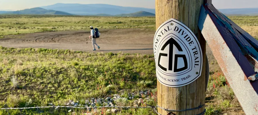A CDT emblem attached to a fence post