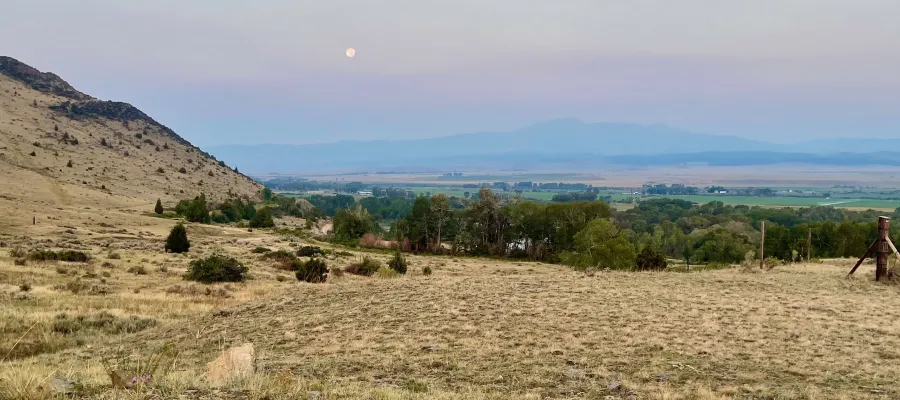 The moon hangs over Jefferson Valley in Montana