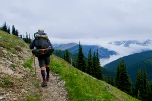 Ralph walking along a ridge overlooking a valley with low clouds