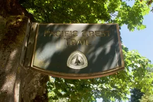 A fancy sign for the PCT hangs from a wall