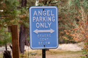 A sign says 'Trail Angel Parking, others sent below'