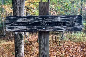 A weathered sign marking the Benton MacKaye Trail