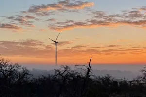 A view of a windmill at sunrise