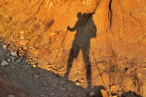 Gravity's shadow on the side of a rock slope
