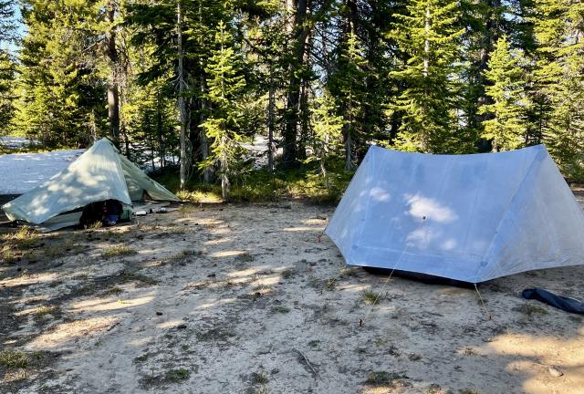 Tents on a flat spot of snow-free ground