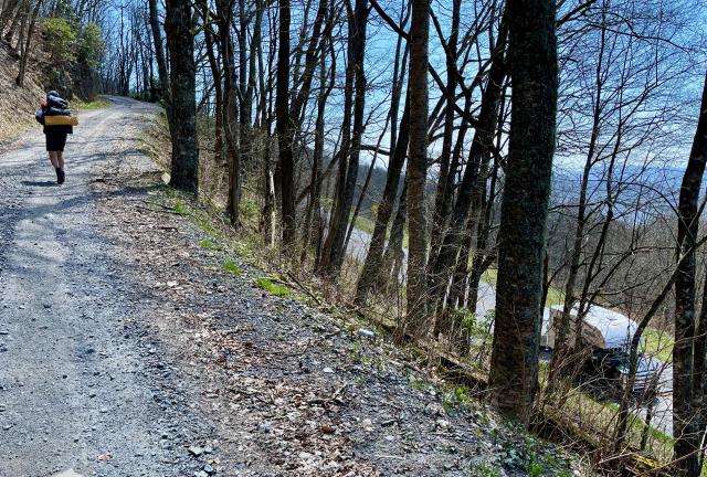 A gravel road climbs above the parkway