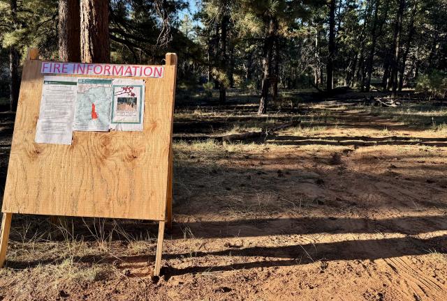 Information about a prescribed burn is posted on a large board