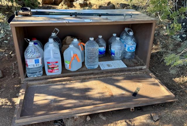 A bear box filled with gallon jugs of water