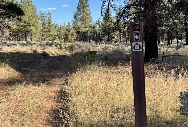 The trail is marked by a small post