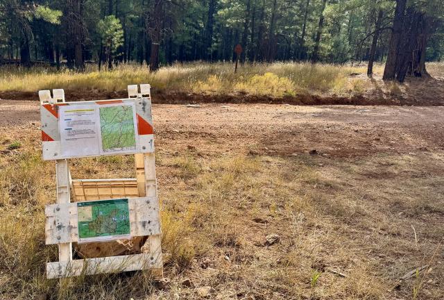 Information posted on a barricade announcing a trail closure