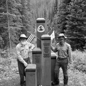 Gravity and Polecat standing at the northern terminus monument