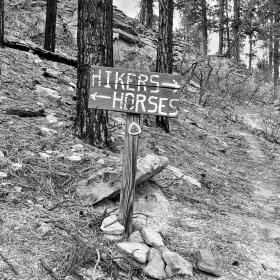 A sign pointing separate trails for hikers and horses